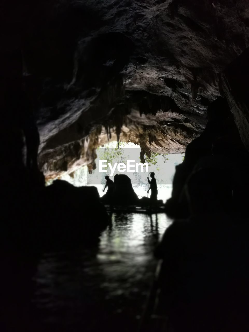 SILHOUETTE PEOPLE ON CAVE