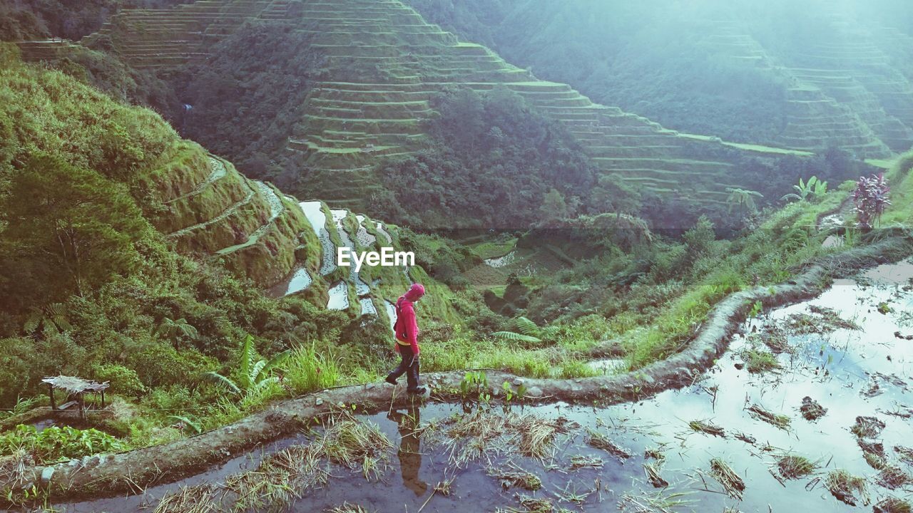 High angle view of man walking on trail against mountains