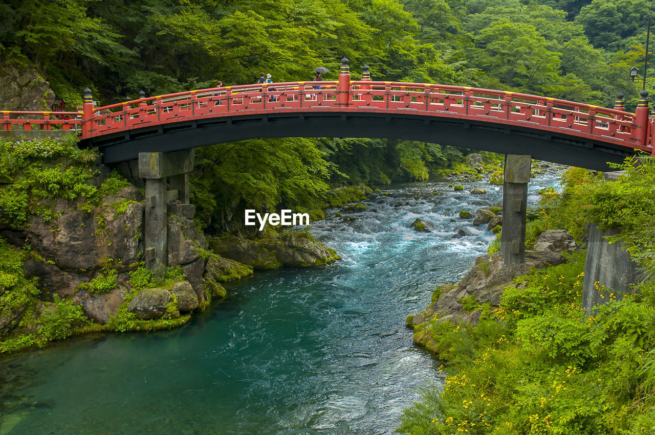 Famous red arch bridge over river in forest at nikko, japan
