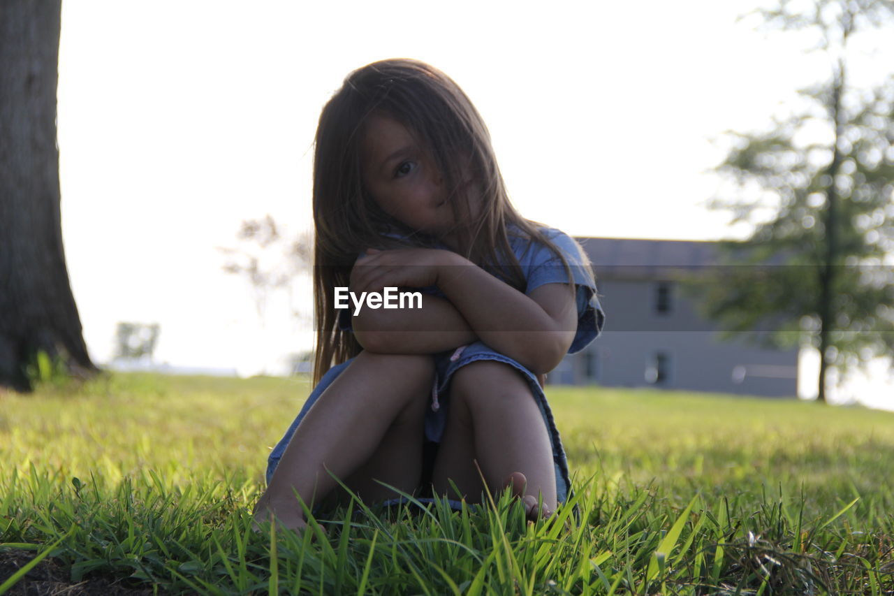 Portrait of cute girl sitting on grass