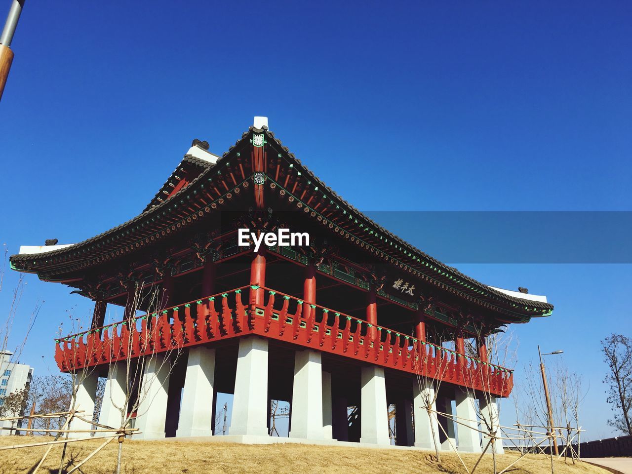 Low angle view of temple building against clear blue sky