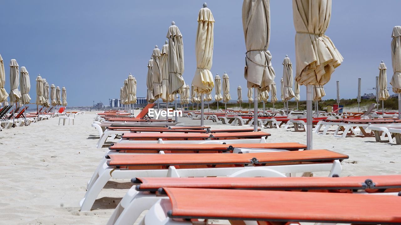Panoramic view of lounge chairs on beach