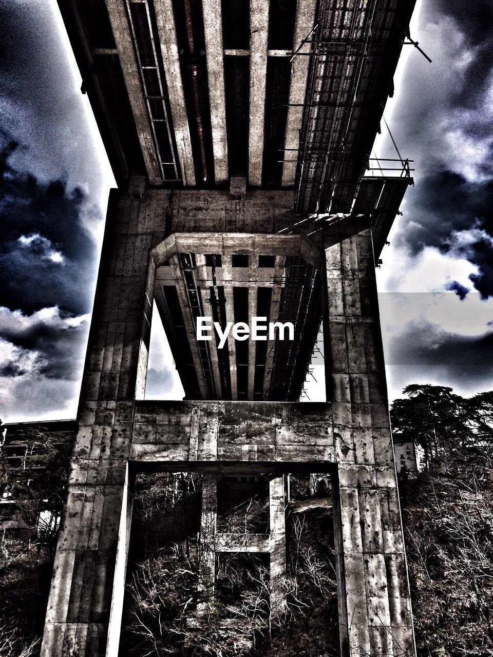 LOW ANGLE VIEW OF BRIDGE WITH BUILDINGS IN BACKGROUND