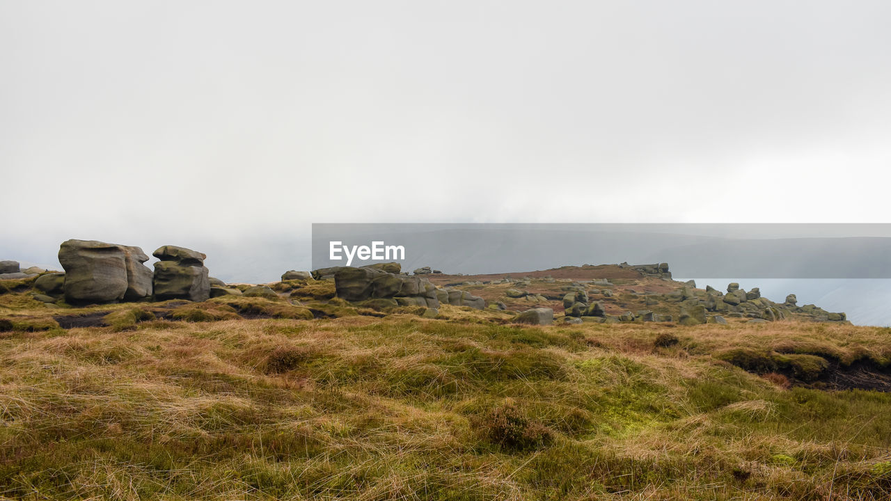 low angle view of rock formations against sky