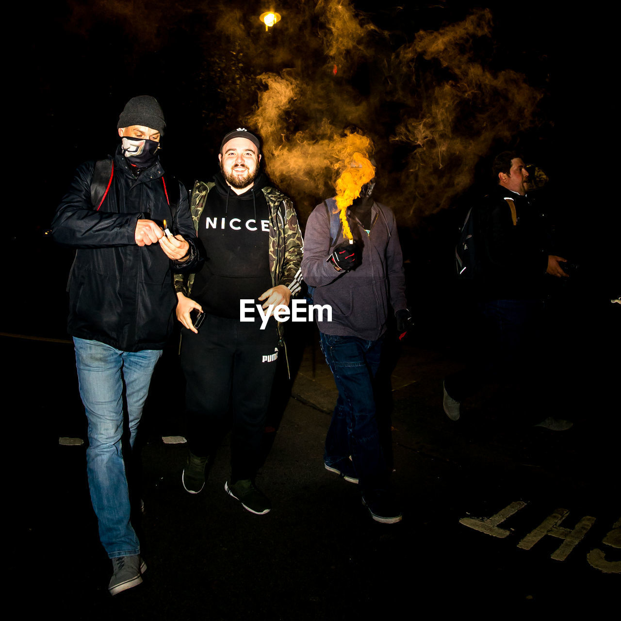 MAN AND WOMAN STANDING AGAINST PEOPLE