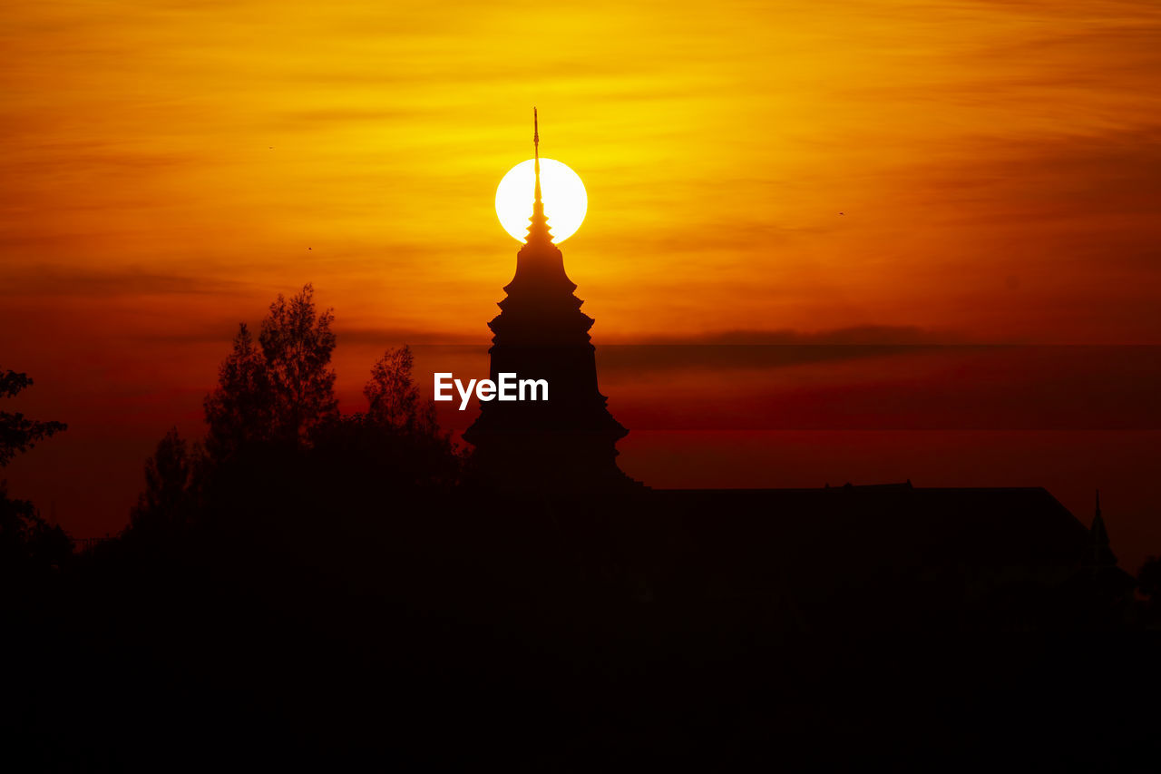 SILHOUETTE OF BUILDING WITH ORANGE SUNSET