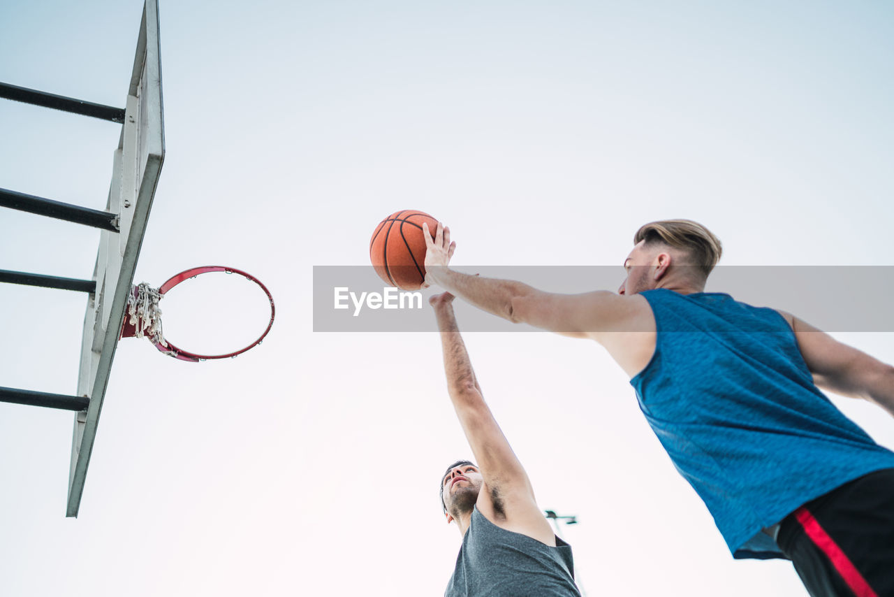 Young man playing with basketball