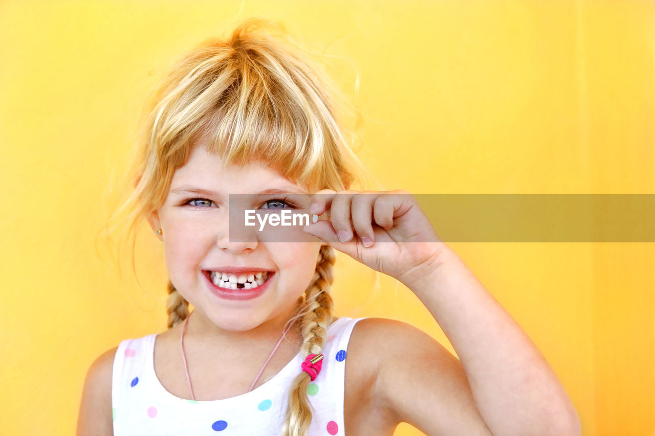 Portrait of smiling young girl with first tooth