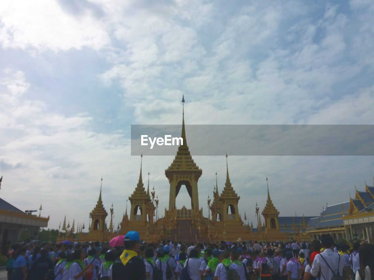 GROUP OF PEOPLE AT TEMPLE AGAINST SKY