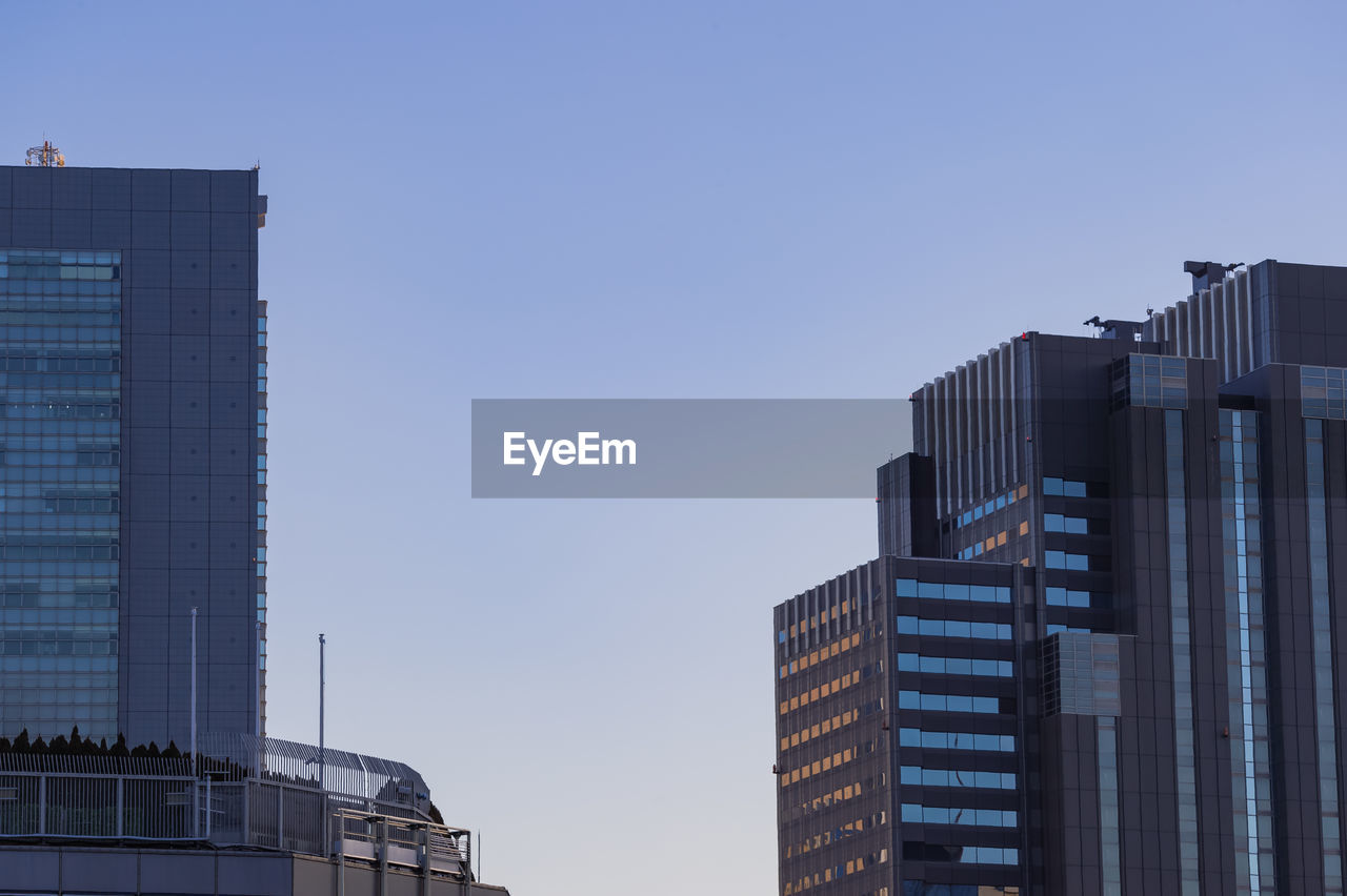 Low angle view of buildings against clear blue sky