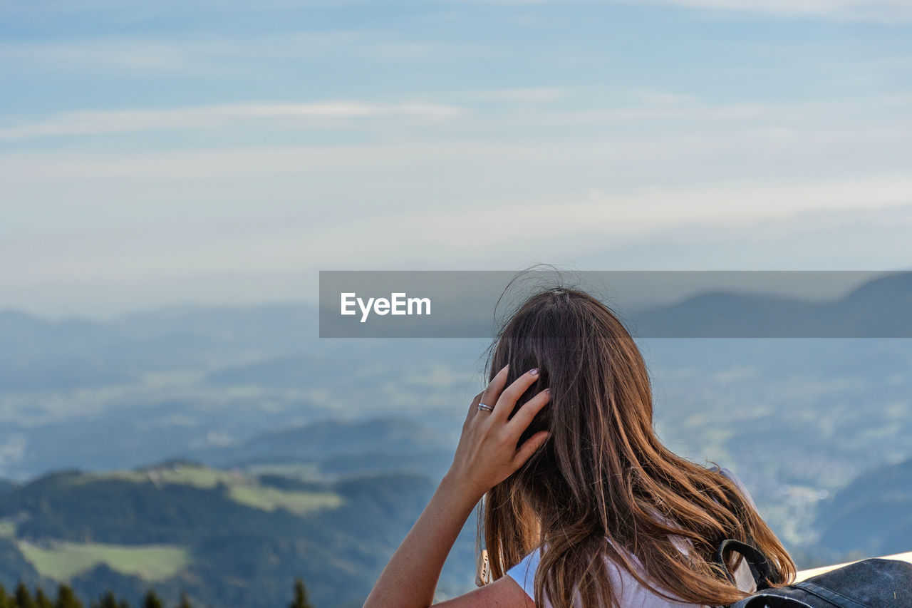 Rear view of woman against hills and valley. view, landscape.