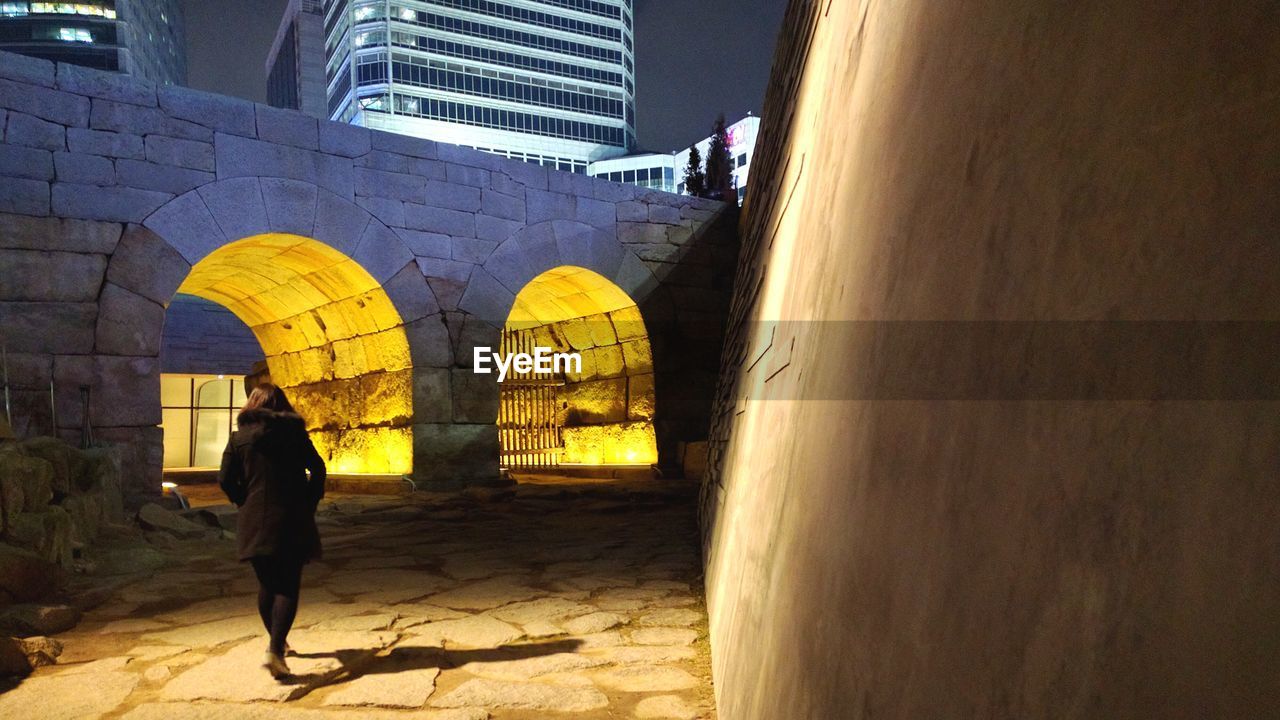 Rear view of woman walking on street 