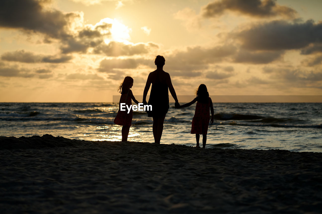 Family vacation sunset happy together at the beach