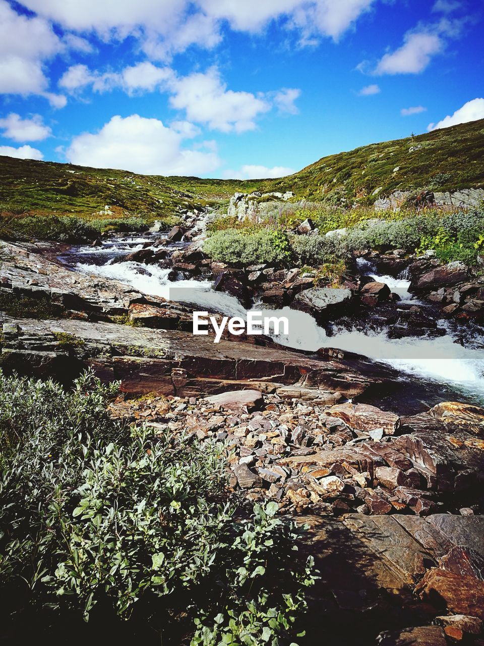 SCENIC VIEW OF RIVER FLOWING THROUGH ROCKS