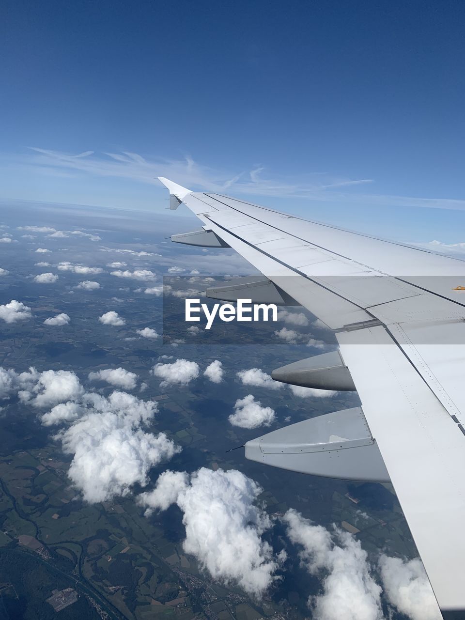 Cropped image of aircraft wing flying in sky