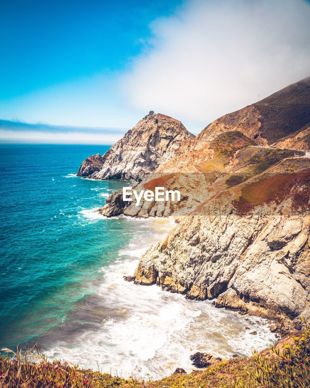 Scenic view of sea and mountains against sky