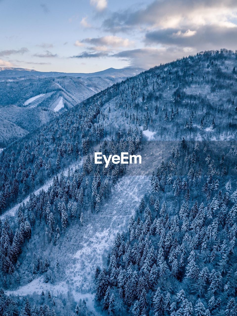 Scenic view of snow covered mountains against sky