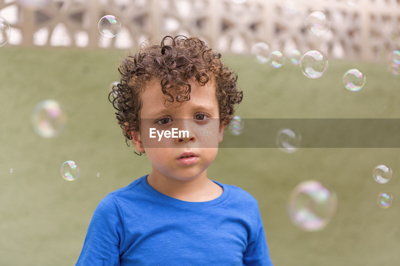 Portrait of boy blowing bubbles