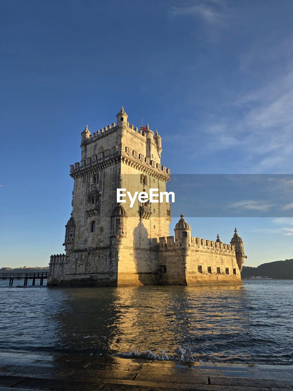architecture, sky, water, built structure, travel destinations, building exterior, sea, history, nature, the past, tower, castle, travel, reflection, building, landmark, city, tourism, blue, fort, no people, water castle, cloud, outdoors, coast, château, land, clear sky, old