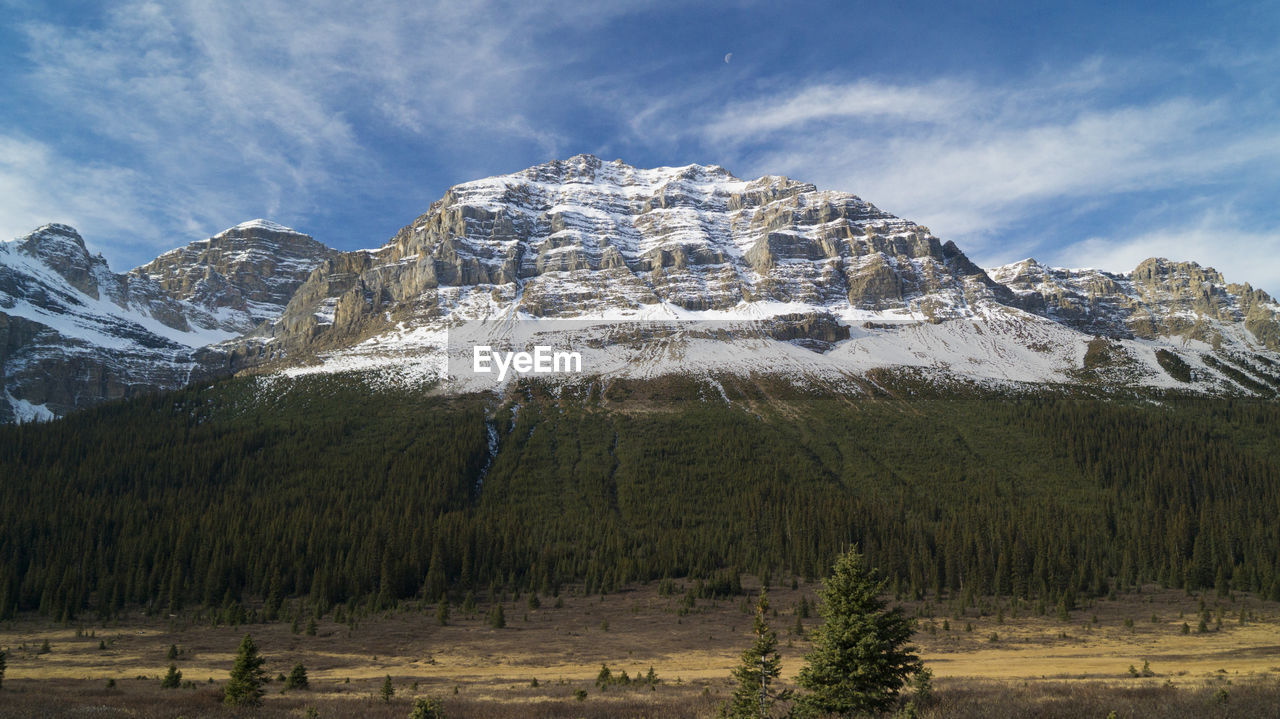 Scenic view of snowcapped mountains against cloudy sky