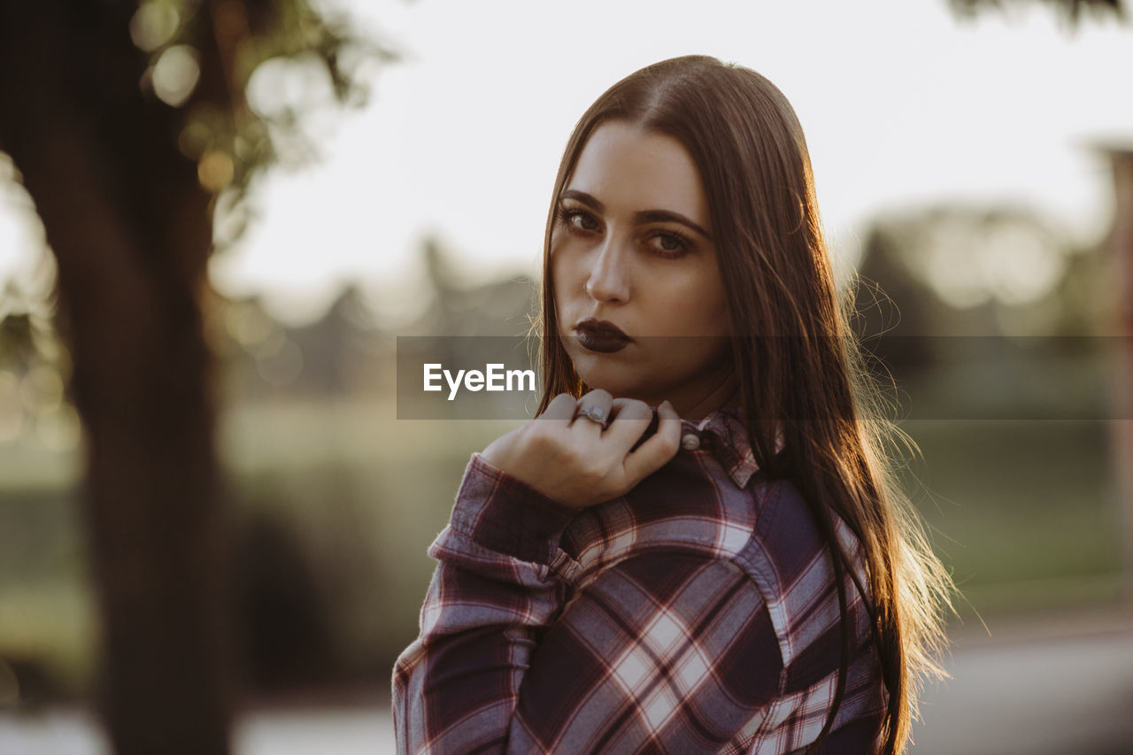 Portrait of beautiful woman holding her collar