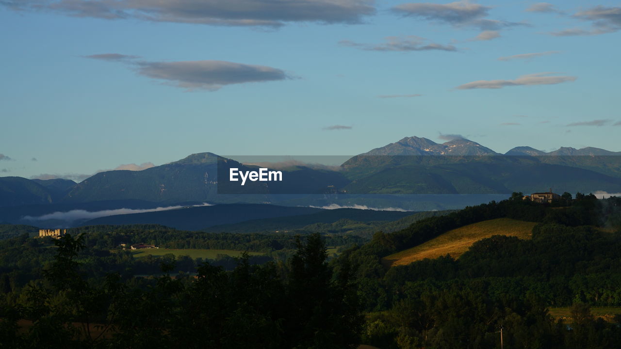 Scenic view of landscape and mountains against sky