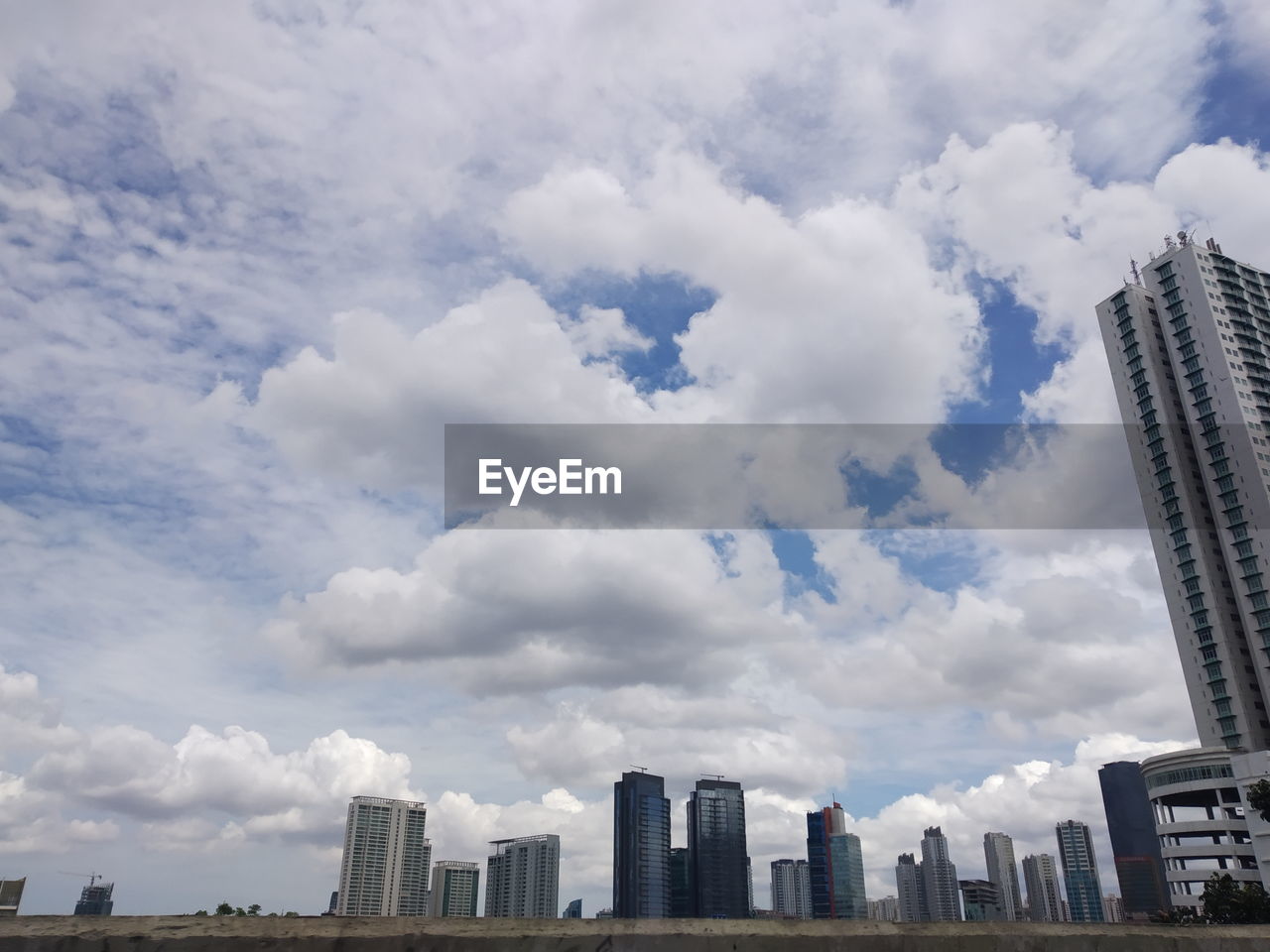 Cloudy sky over office building in business district of jakarta