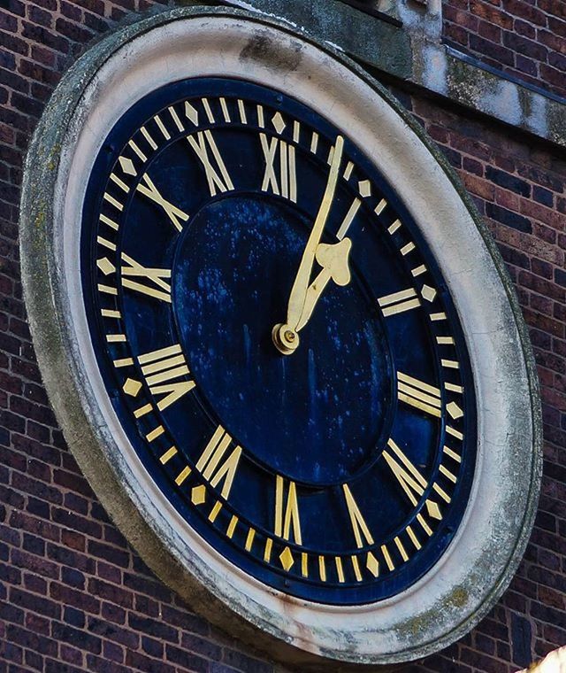 CLOSE-UP OF CLOCK ON WALL