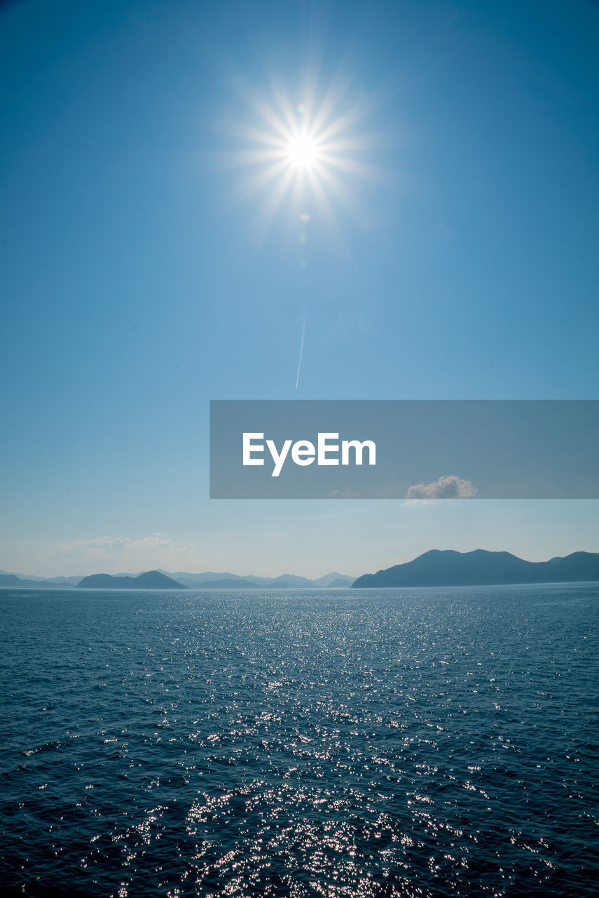 SCENIC VIEW OF SEA AGAINST BRIGHT SKY