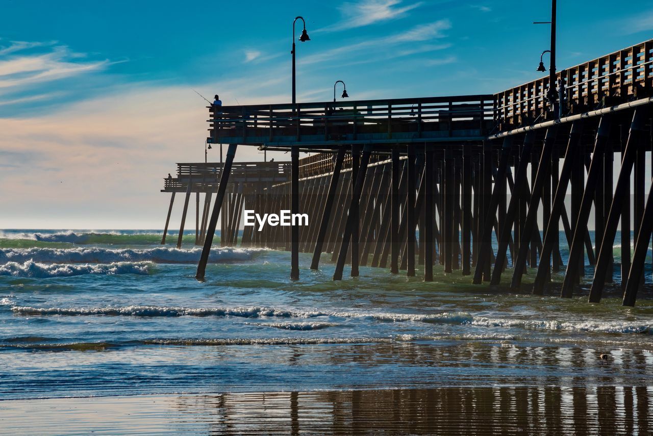 Pier over sea against sky