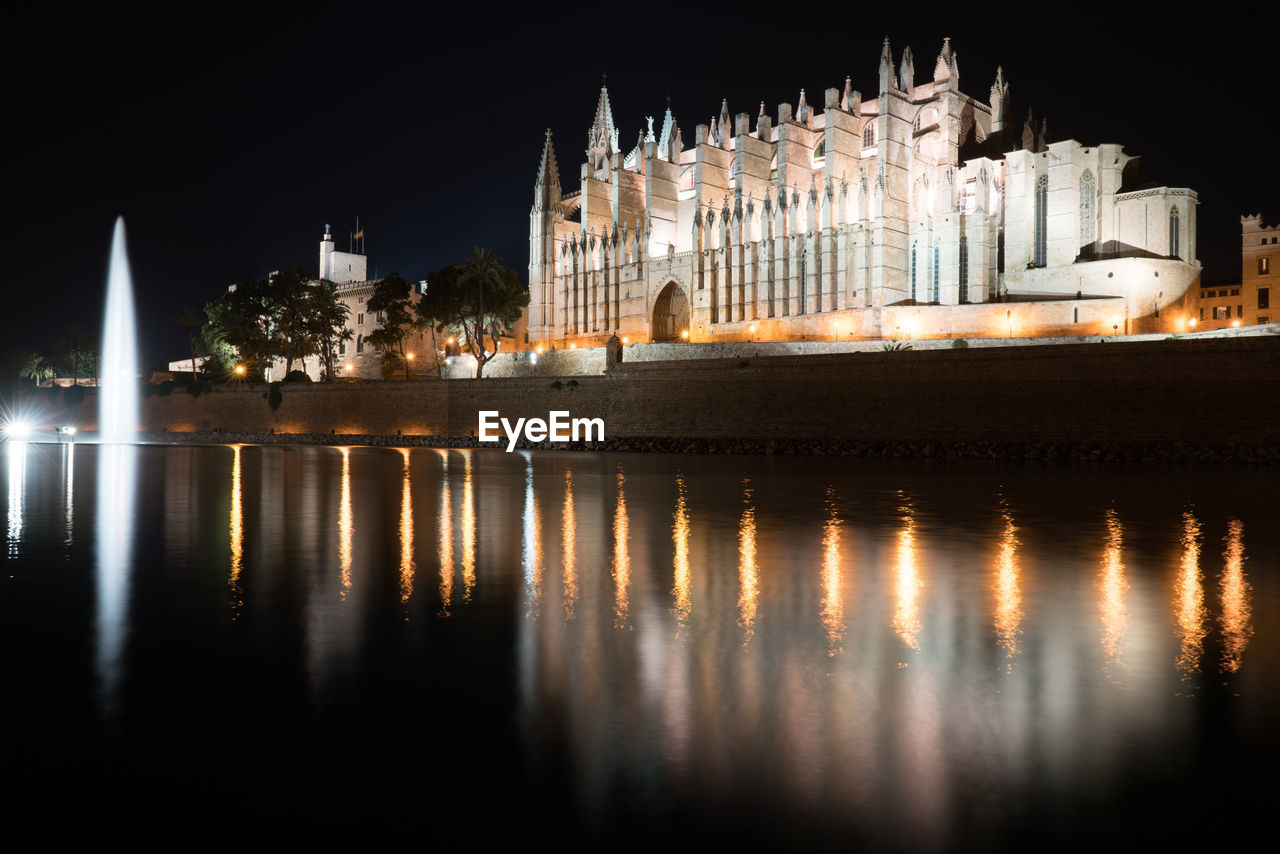 Reflection of illuminated buildings in water at night