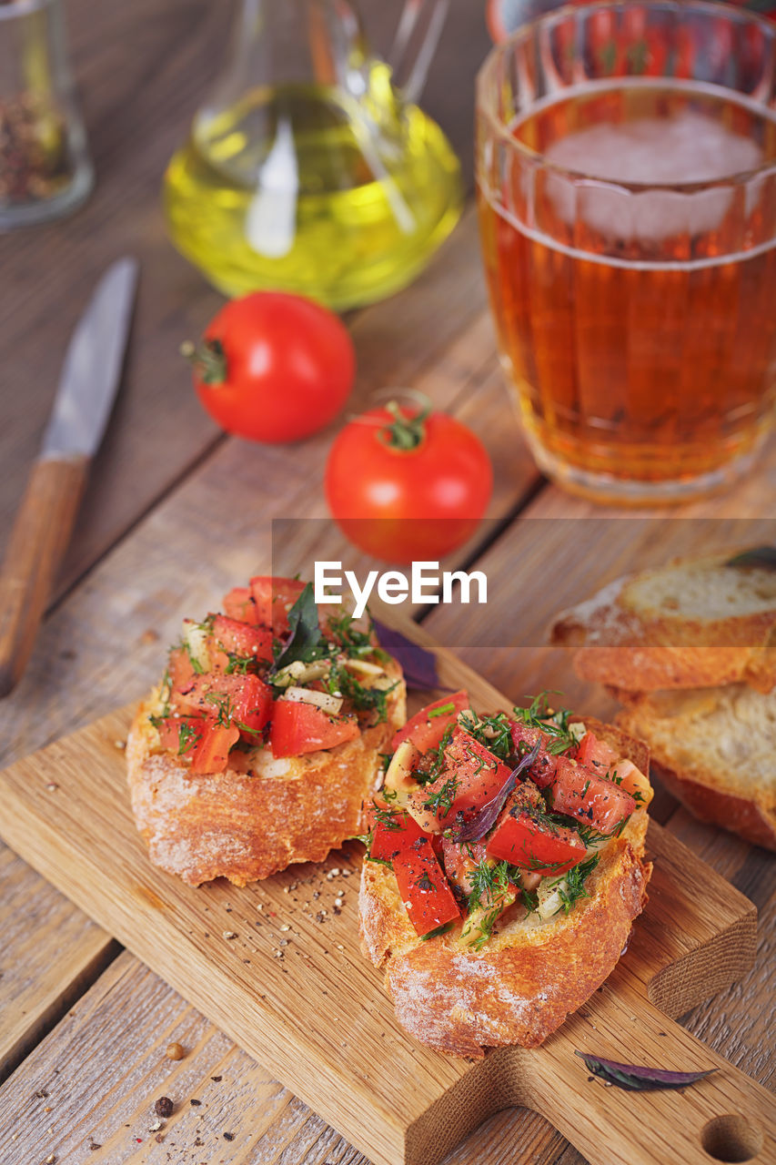 Italian bruschetta with chopped tomatoes, basil, herbs and olive oil on grilled crusty bread