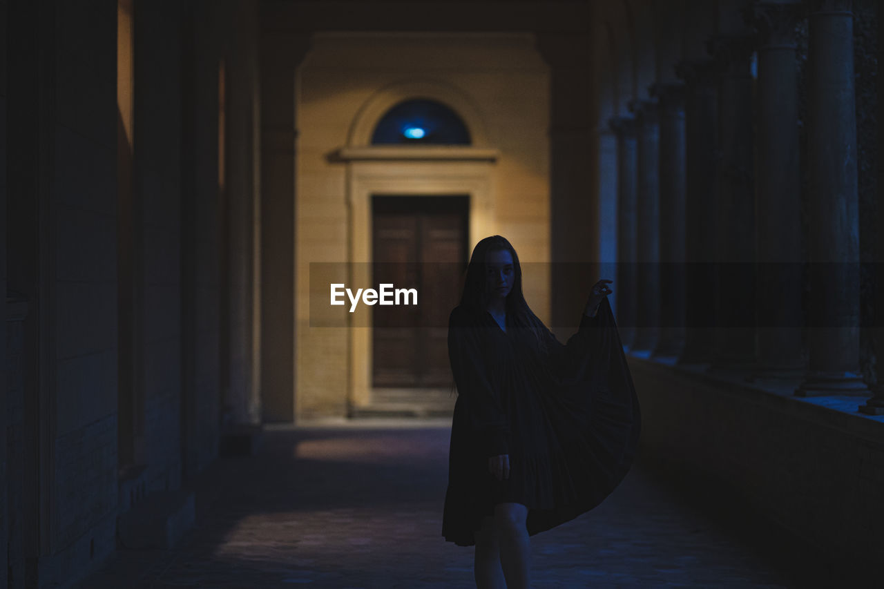 Woman walking in corridor of building