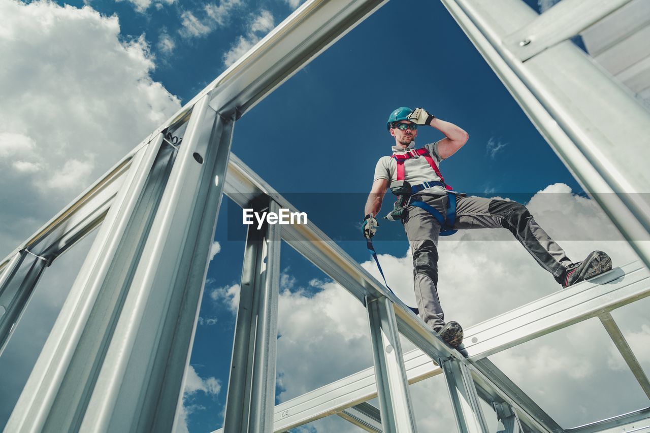 Low angle view of man working at construction site