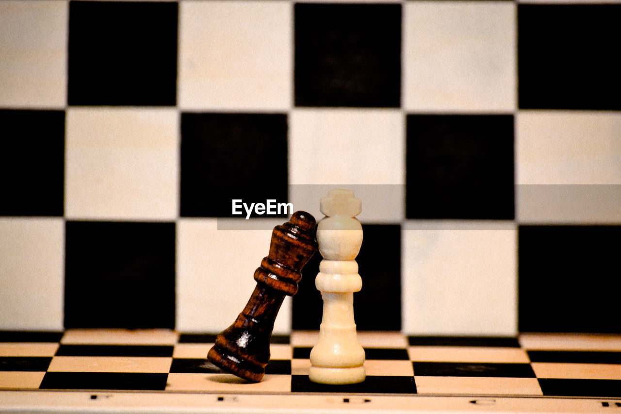 LOW ANGLE VIEW OF CHESS PIECES ON FLOOR