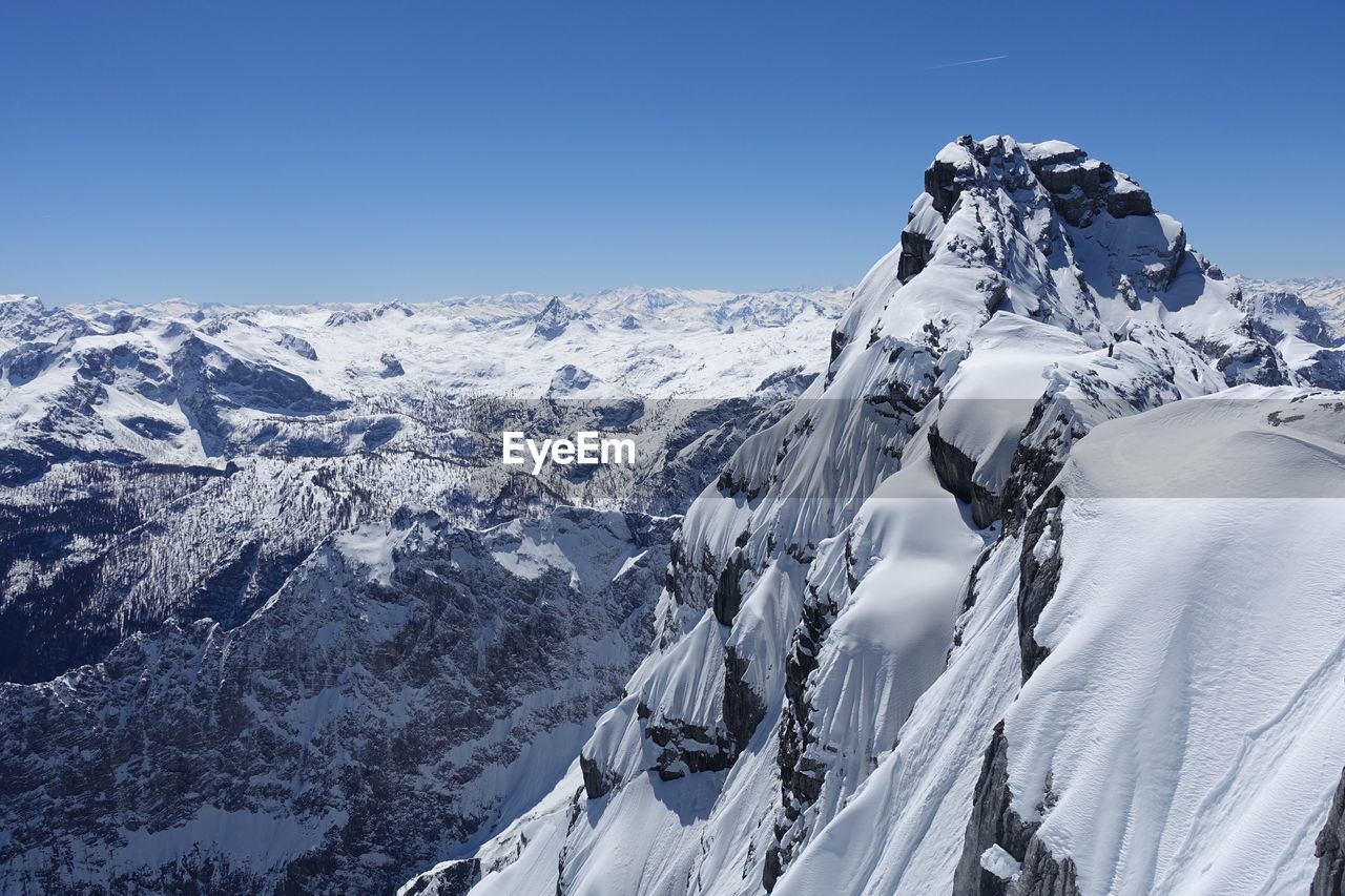 SCENIC VIEW OF SNOWCAPPED MOUNTAIN AGAINST BLUE SKY