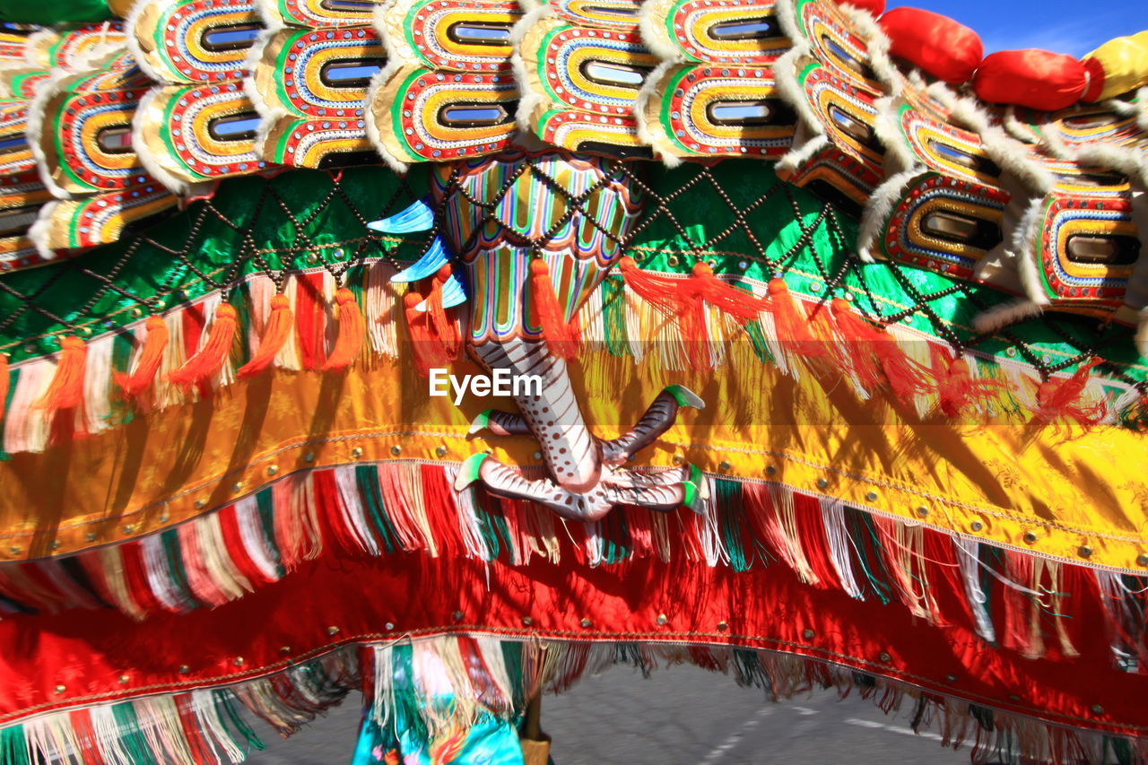 Person with artificial dragon on road during chinese new year celebration