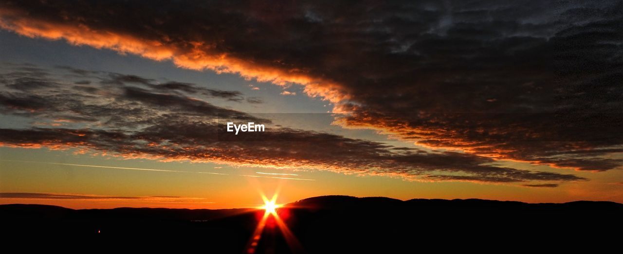 SCENIC VIEW OF SILHOUETTE LANDSCAPE AGAINST DRAMATIC SKY