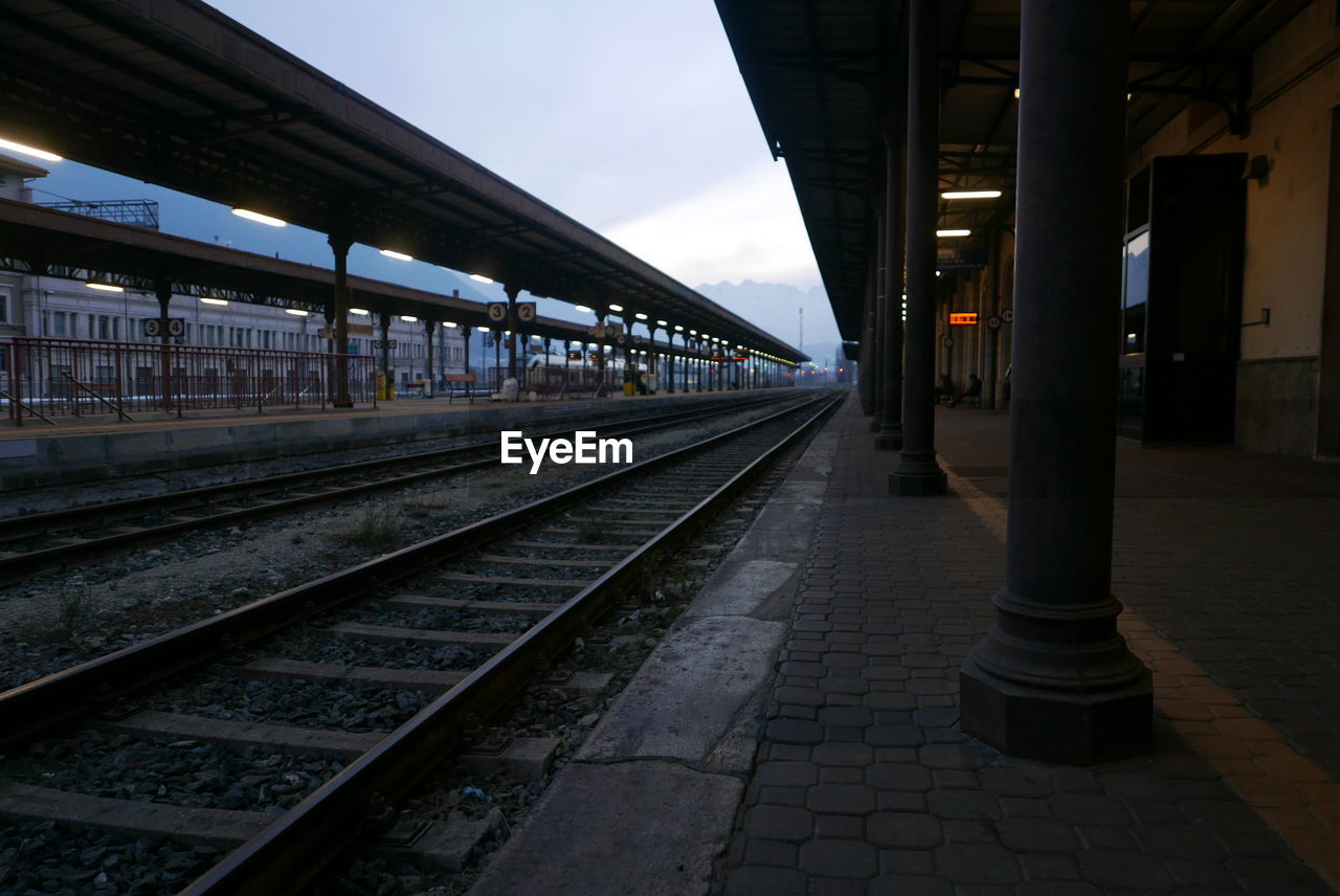 RAILROAD TRACKS ON RAILROAD STATION PLATFORM