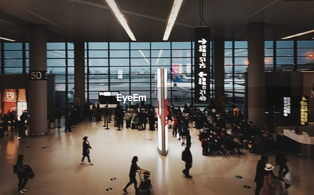 PEOPLE WALKING IN AIRPORT LOBBY