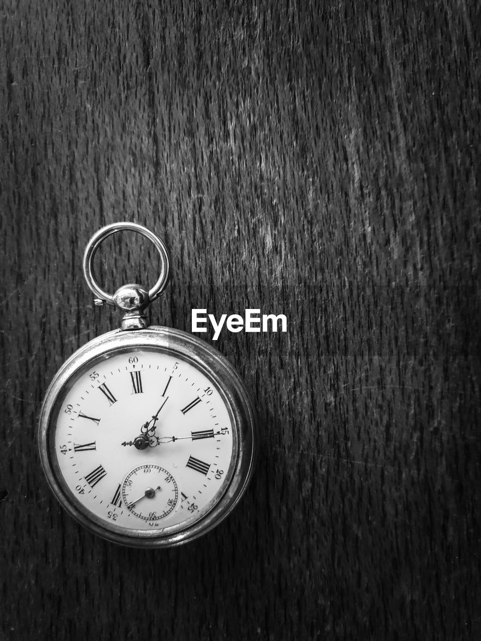 High angle view of pocket watch on table