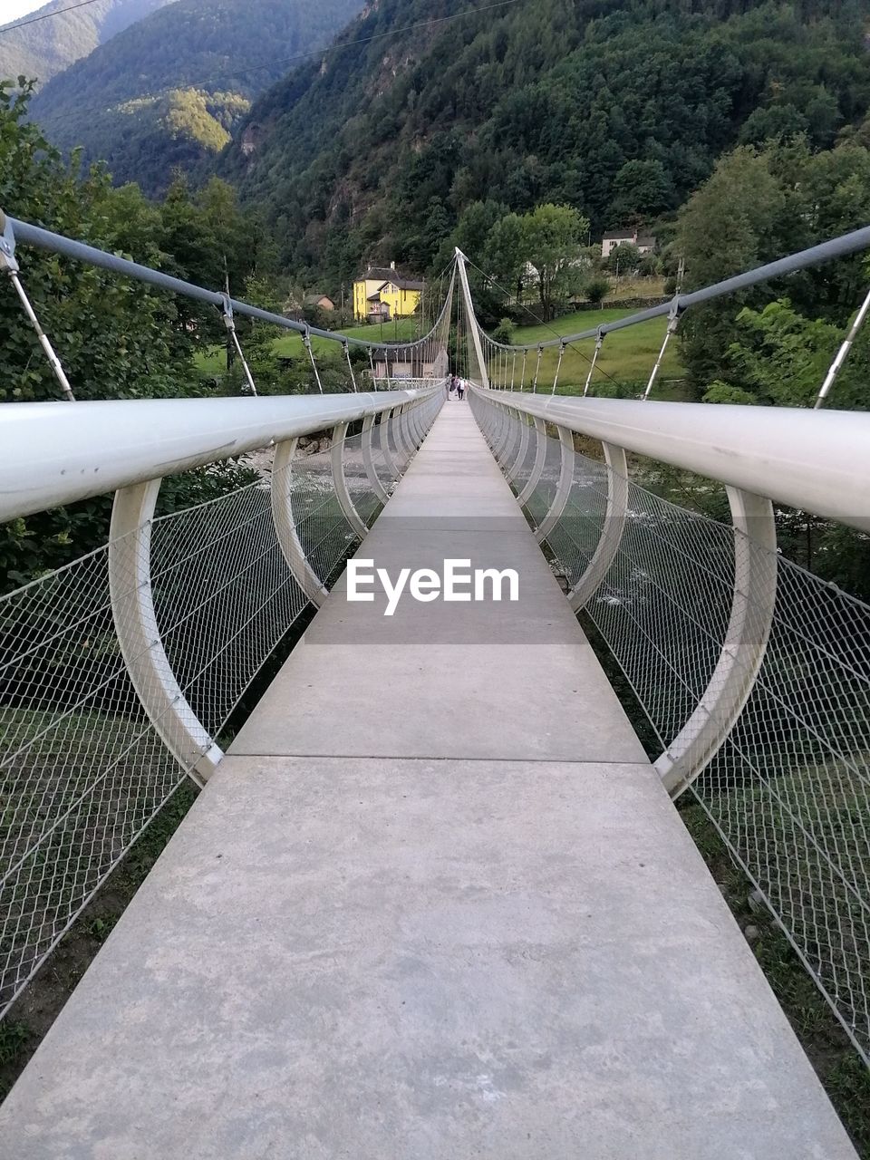 mountain, bridge, suspension bridge, the way forward, nature, railing, architecture, built structure, transportation, tree, scenics - nature, environment, plant, mountain range, beauty in nature, land, footbridge, no people, tranquility, day, landscape, sky, outdoors, travel, travel destinations, tranquil scene, forest, non-urban scene, water, tourism, rope bridge, diminishing perspective, road, rope, footpath