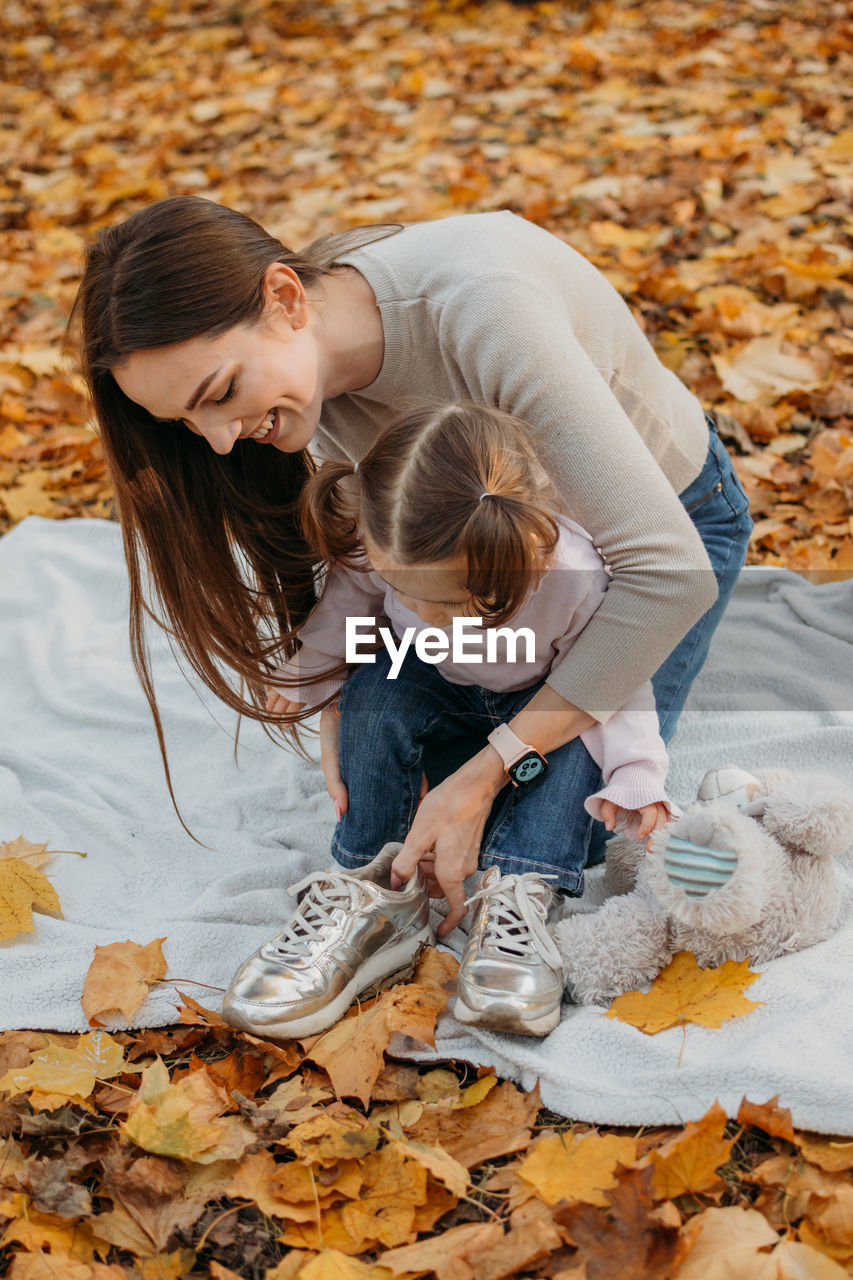 Dressing child for autumn fall outdoor play. autumn fashion for baby toddler, kids. autumn outdoor