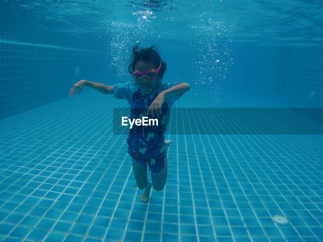 Full length of girl swimming in pool