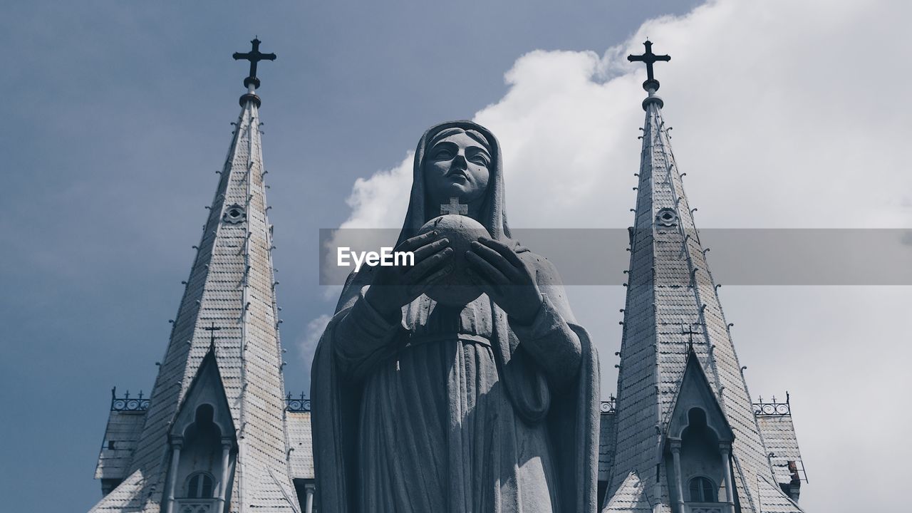 Low angle view of statue against building