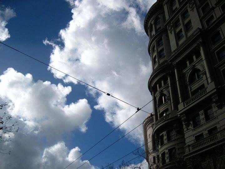 LOW ANGLE VIEW OF POWER LINES AGAINST CLOUDY SKY