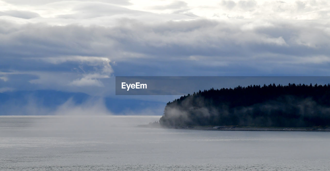 Dramatic clouds and fog on the ocean shore