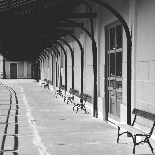 Row of empty benches at railroad station platform