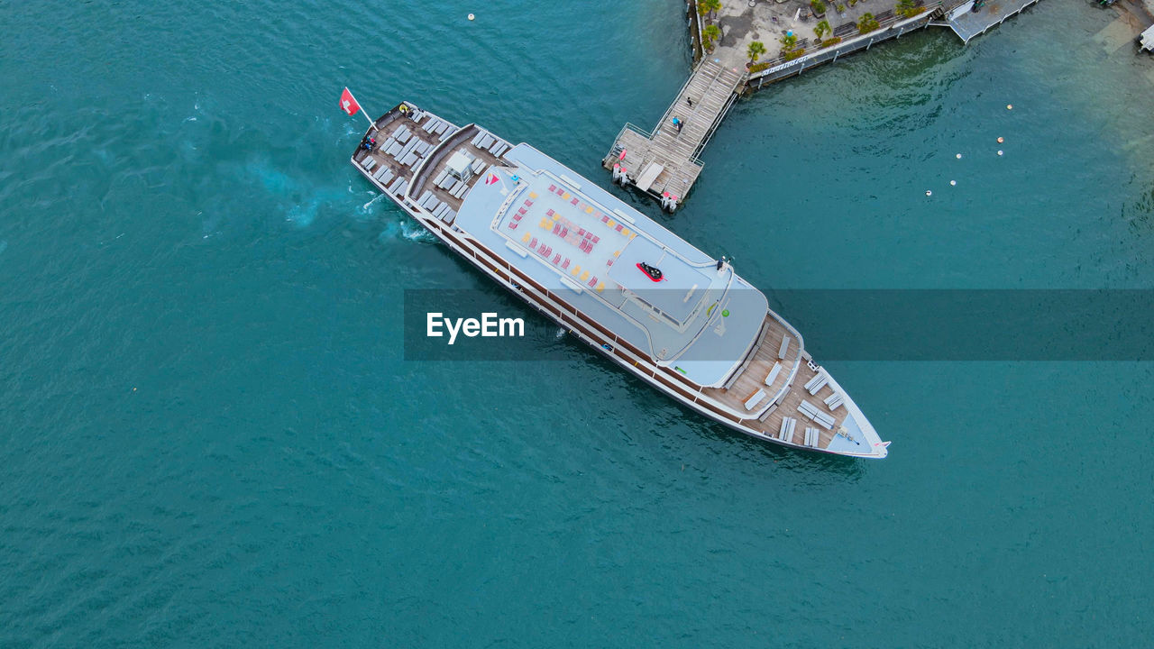 HIGH ANGLE VIEW OF SHIP SAILING IN WATER