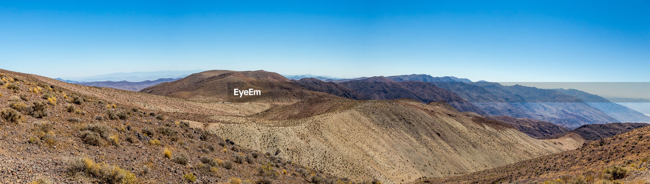 Scenic view of mountains against clear blue sky